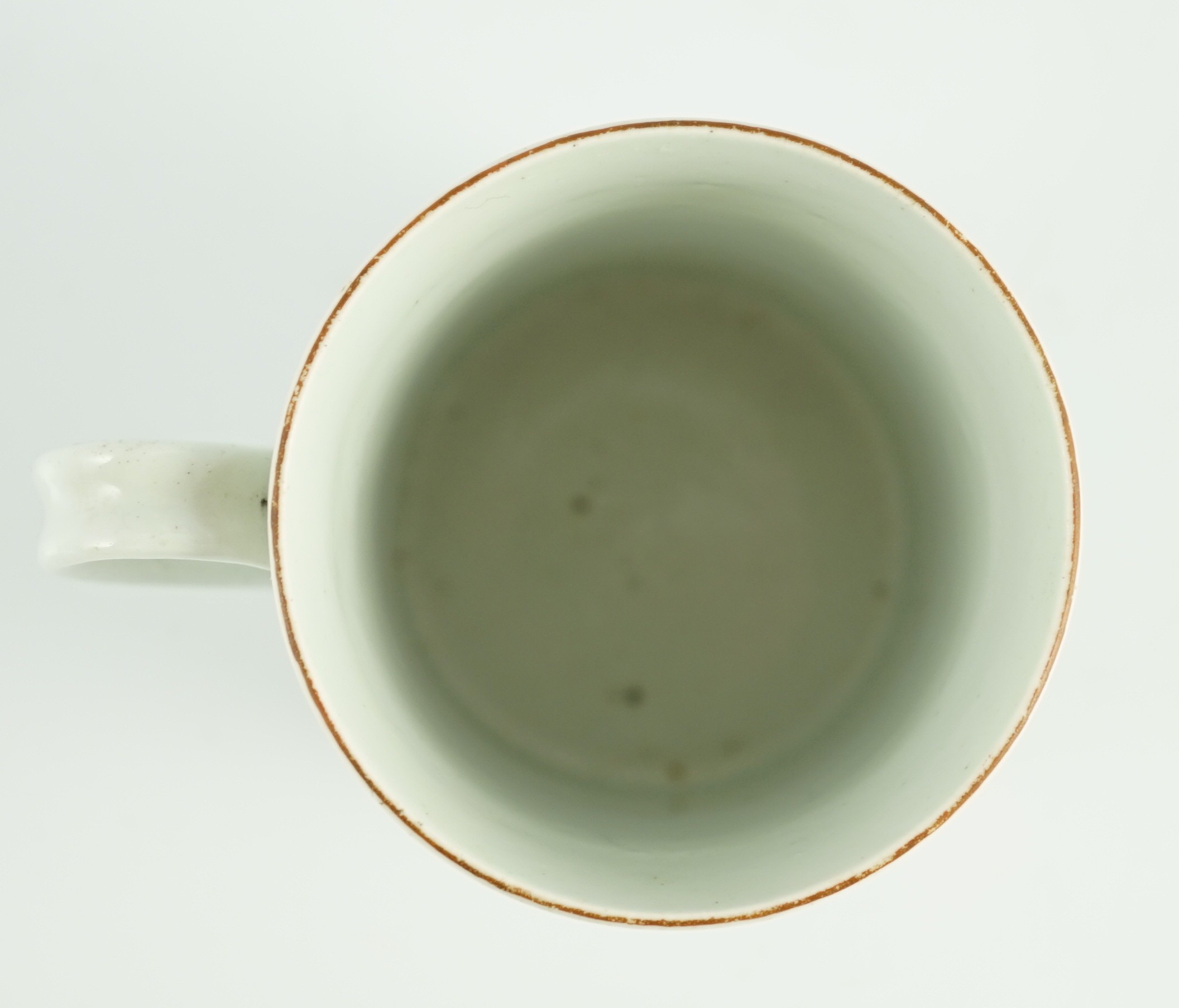 A rare Worcester polychrome 'flower and rockwork' small mug, c.1753-54, 9cm high